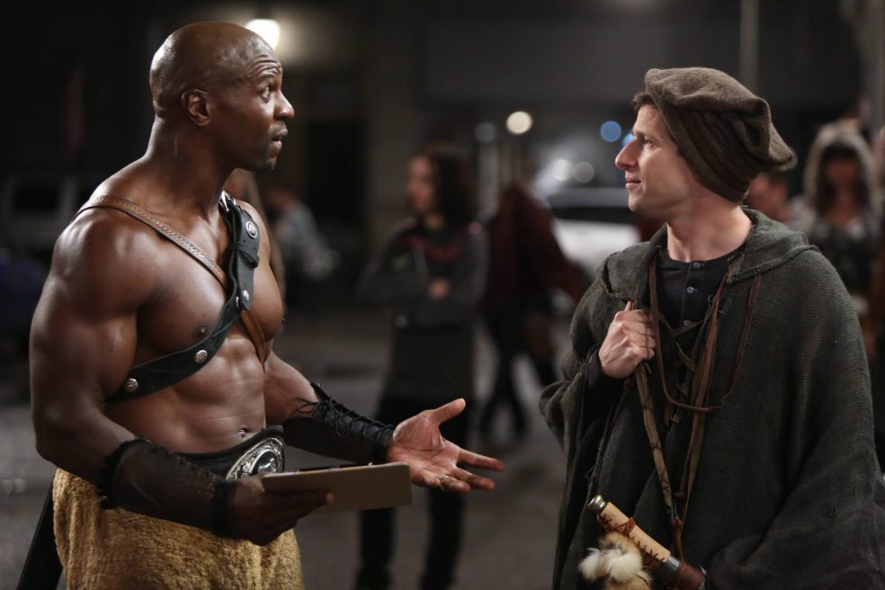 A snapshot from Brooklyn Nine Nine, showing Jeffords and Perolta dressed as fantasy characters, talking to each other outside a convention